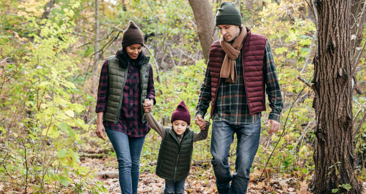 parents and child hiking in the woods