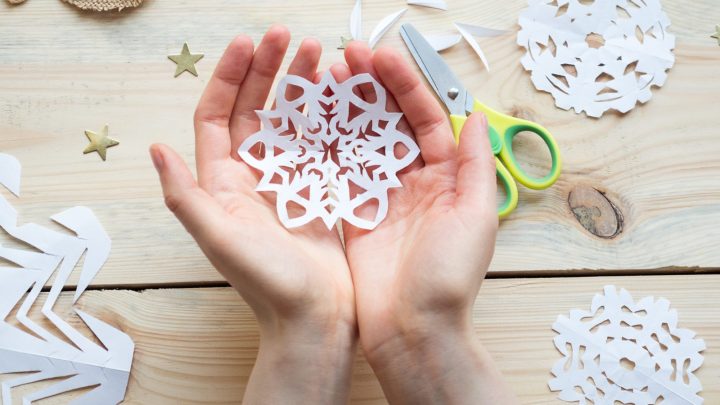 paper snowflake in hands