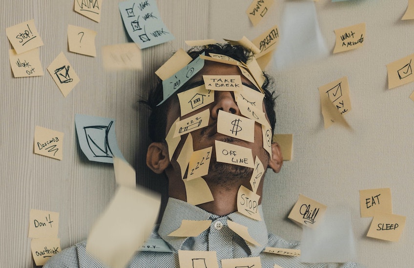 man covered in various post it notes