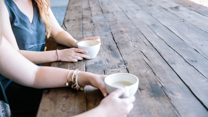 hands holding coffee cups