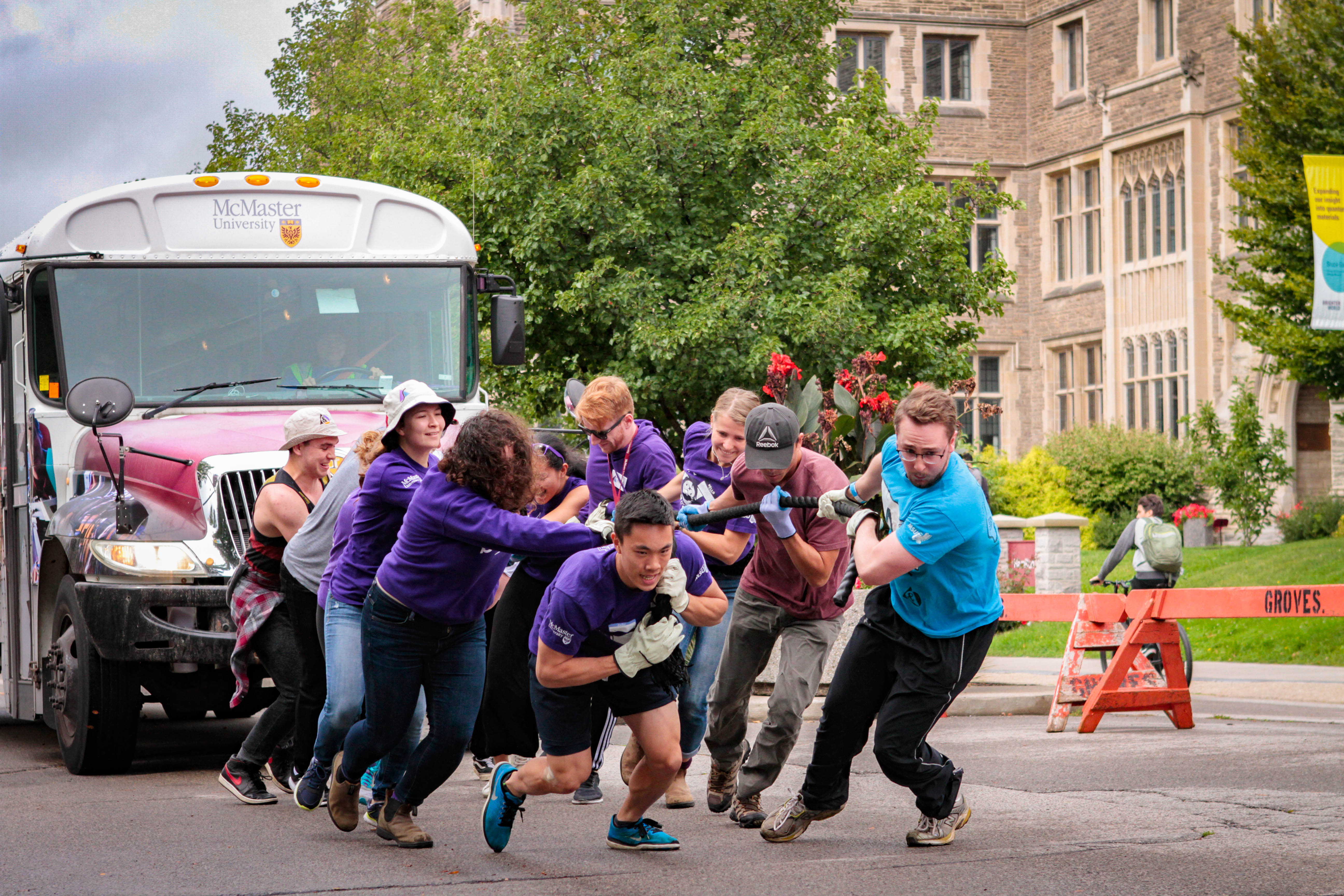 McMaster university employees pull McMaster bus as part of the United Way Campaign.